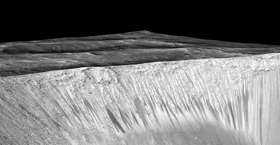 The dark streaks here are hypothesized to be formed by flow of briny liquid water on Mars.