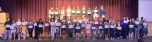 The Class of 2021 IB Diploma Candidates hold their certificates proudly at their ceremony on November 19, 2019. 